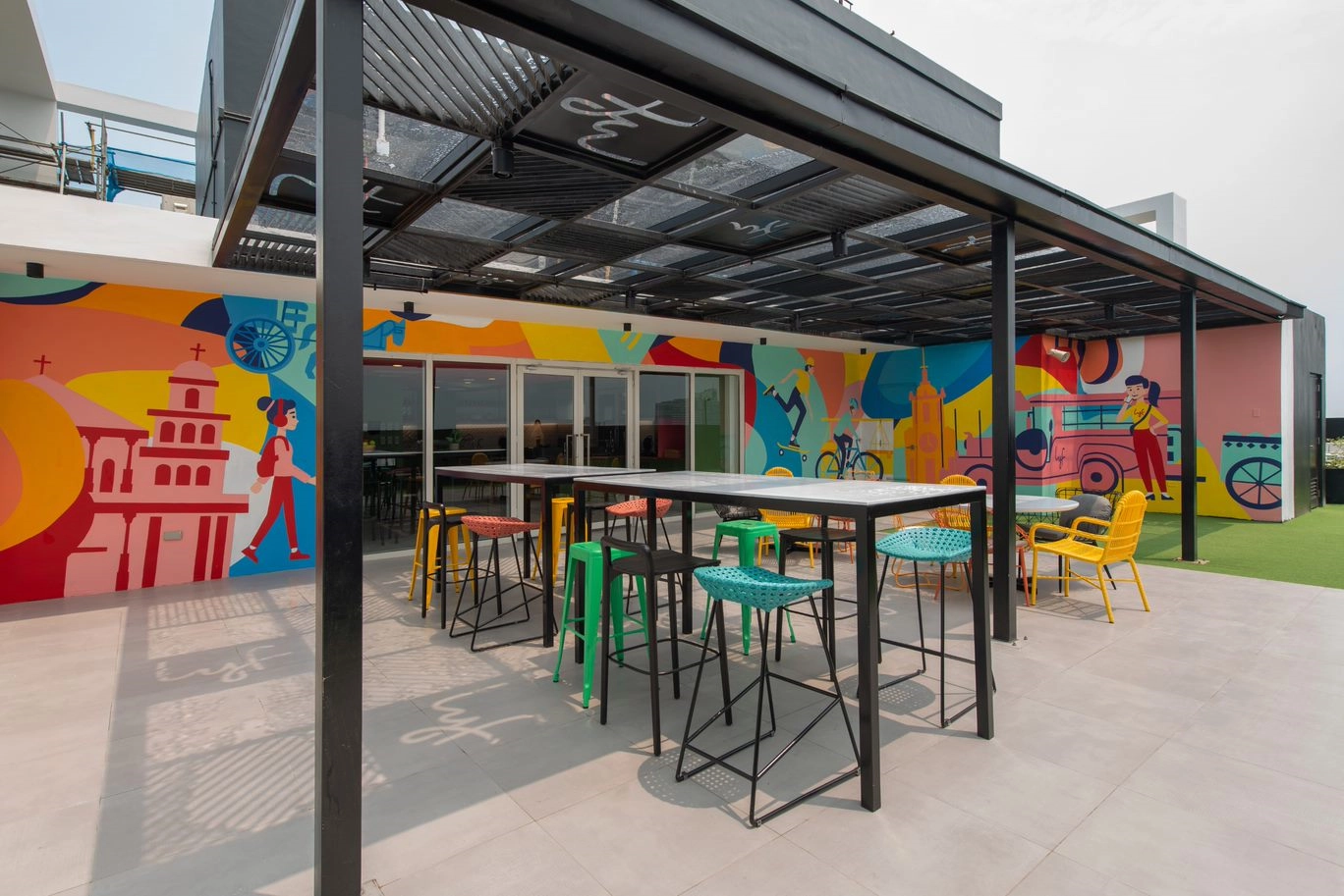 a colorful patio with chairs and table
