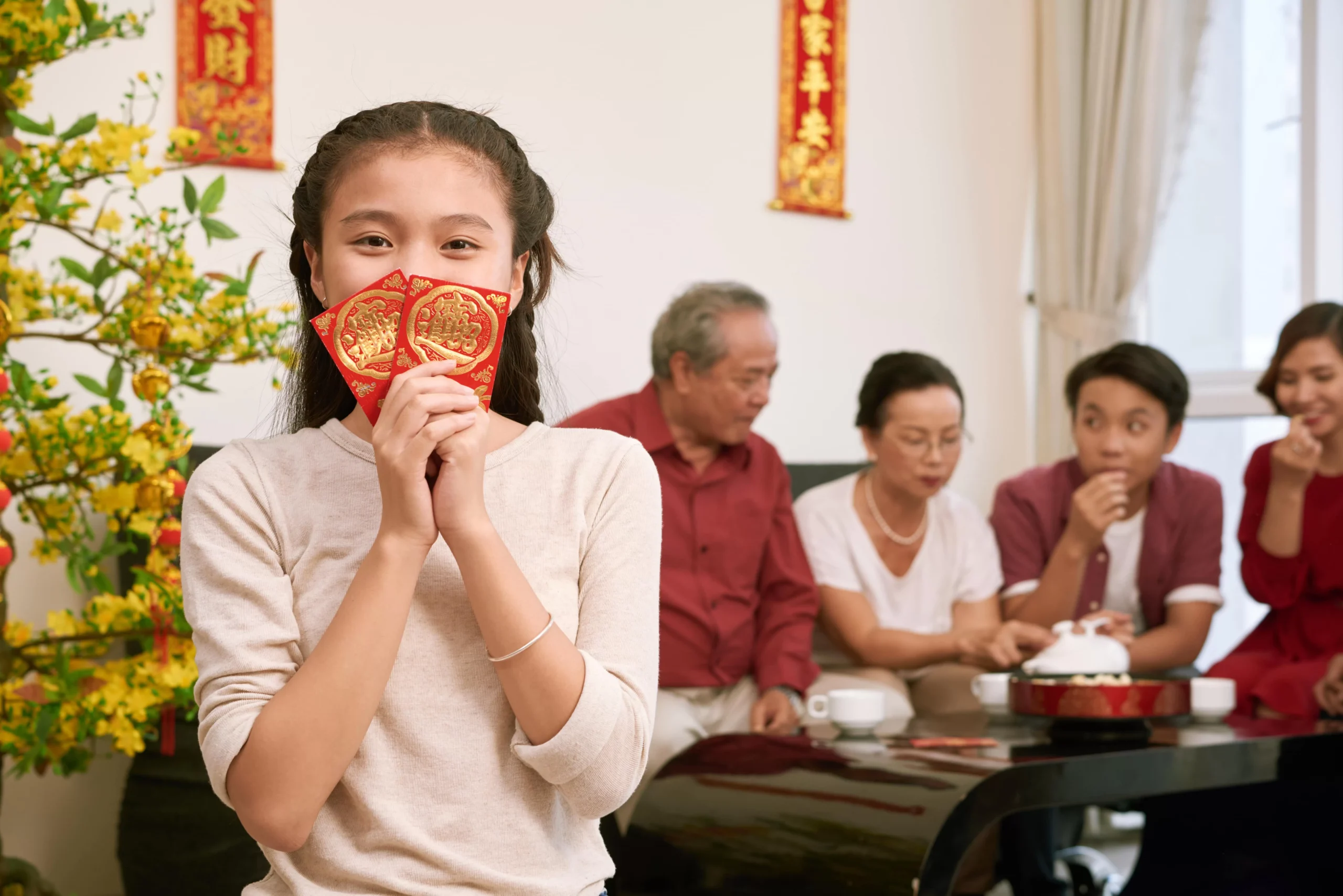 happy girl holding red envelopes