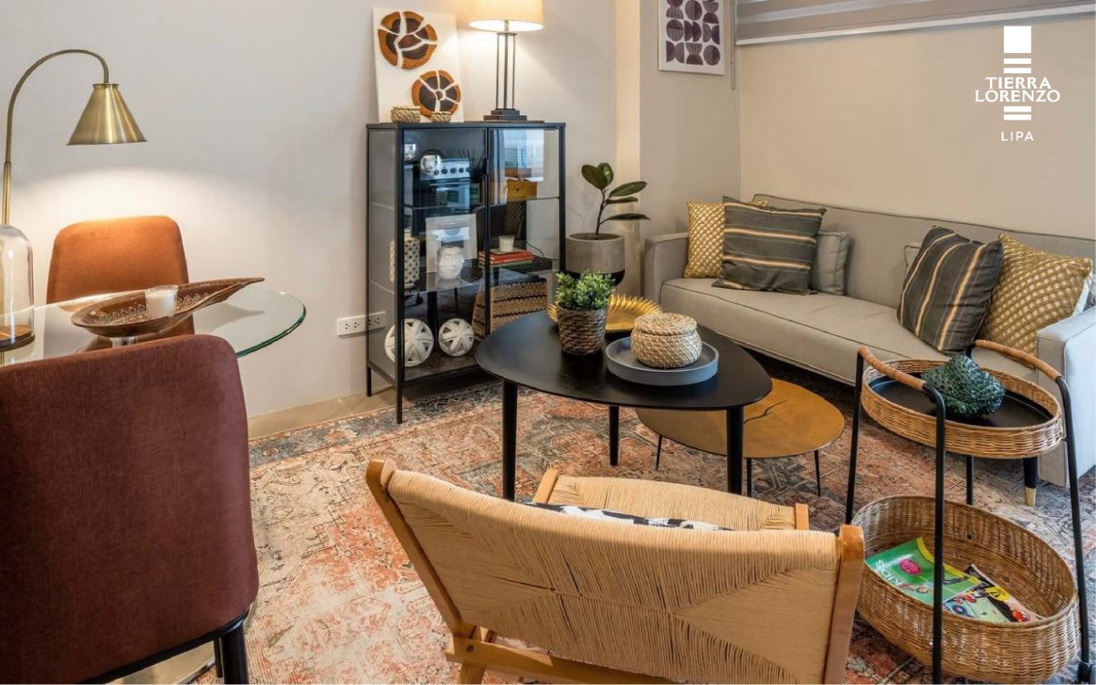 Tierra Lorenzo Lipa Model Unit living room with a couch, chairs, and condo indoor plant at the table