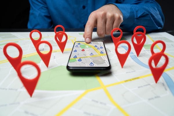 Person pointing at map with location pins