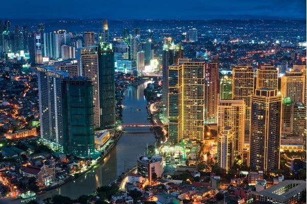 City skyline at night with river and lights