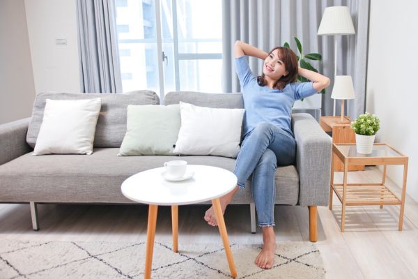 Woman relaxing on a couch in a modern living room