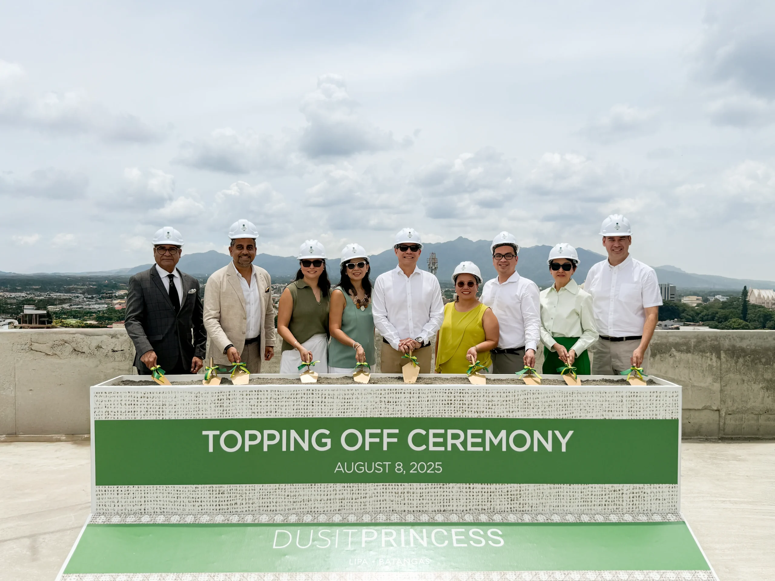 Executives at Dusit Princess Lipa topping off ceremony holding ceremonial trowels