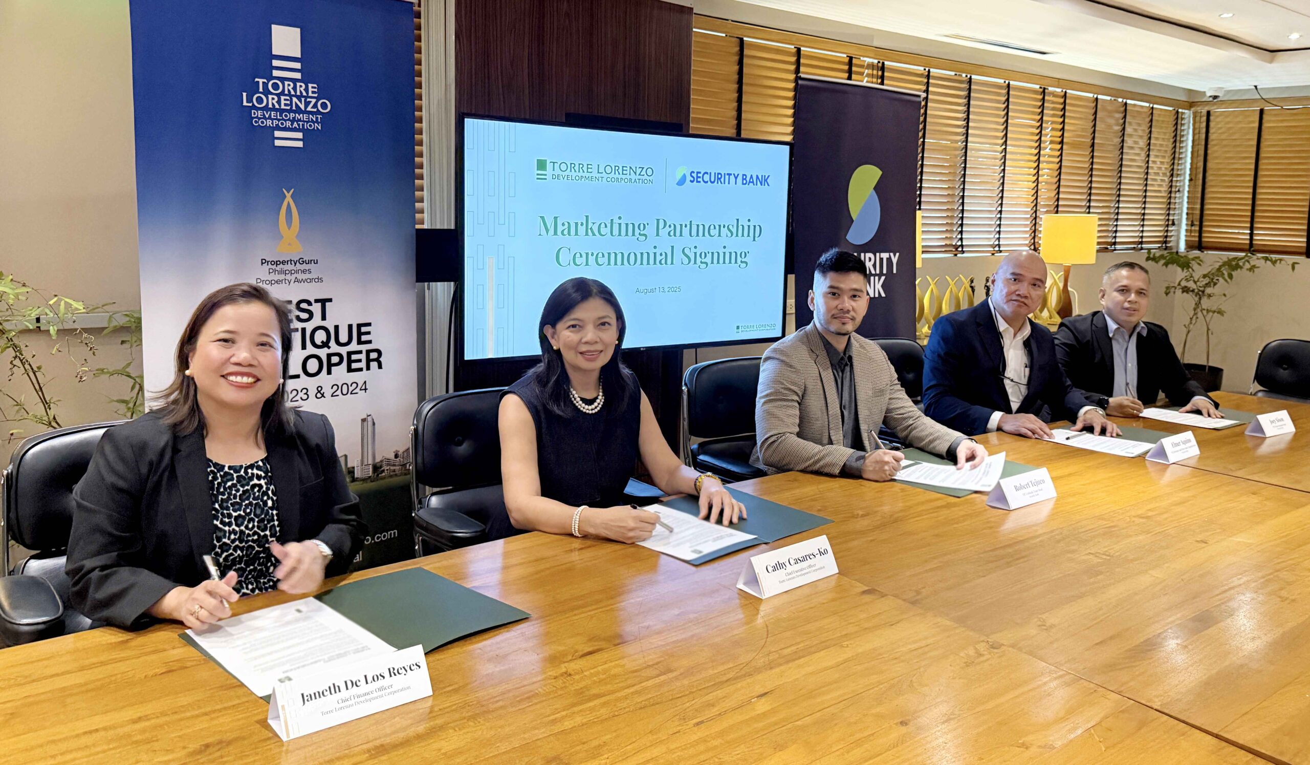 Business leaders signing marketing partnership agreement at conference table