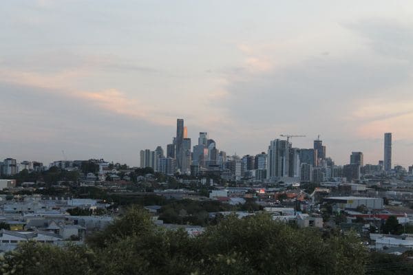 Urban skyline at sunset with buildings and residential area in foreground